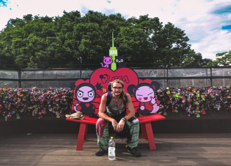 Ziggy sitting at a love heart bench at the top of the Seoul Tower, South Korea.